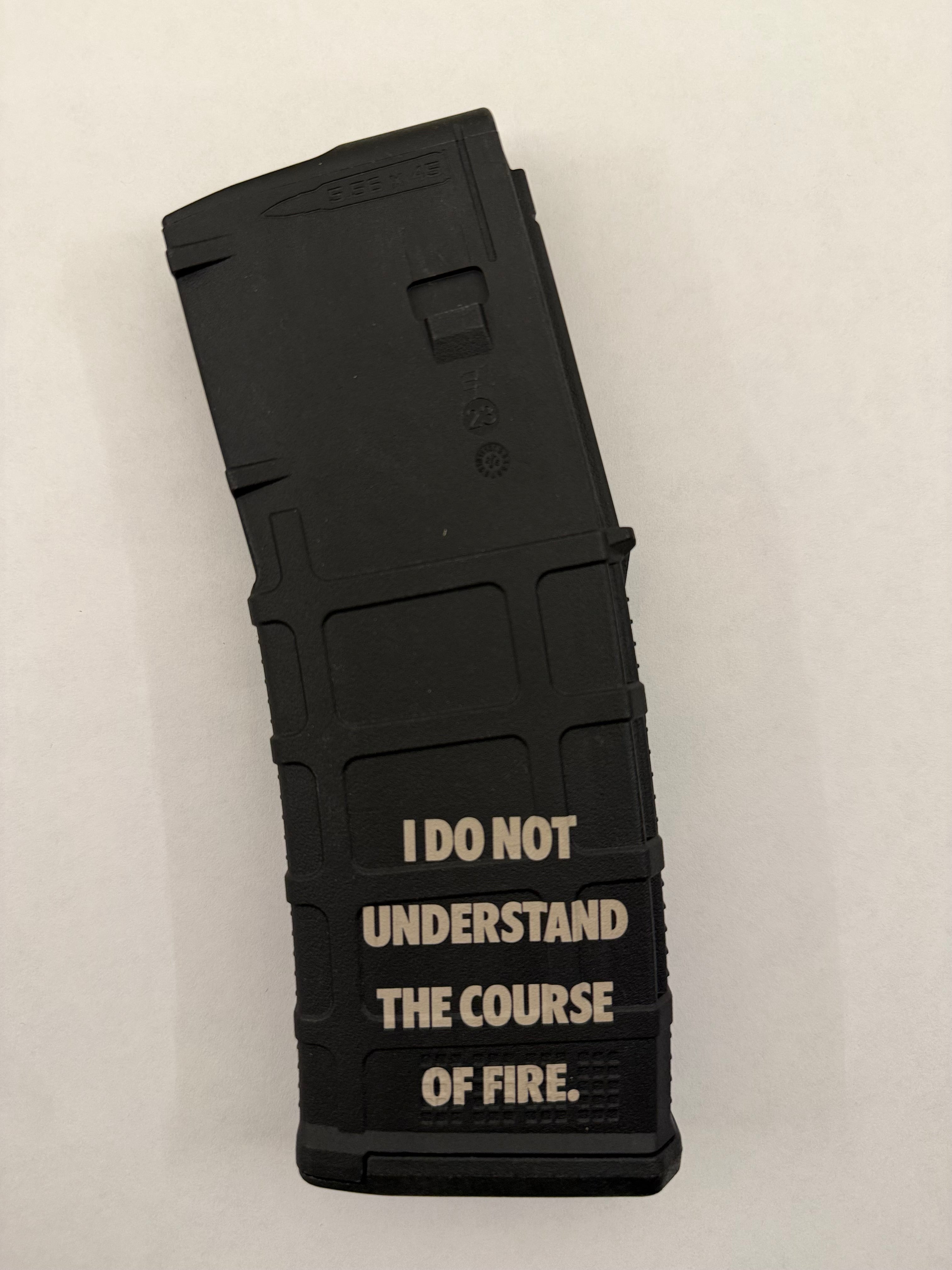 Black PMAG with "I DO NOT UNDERSTAND THE COURSE OF FIRE" on a white background. 